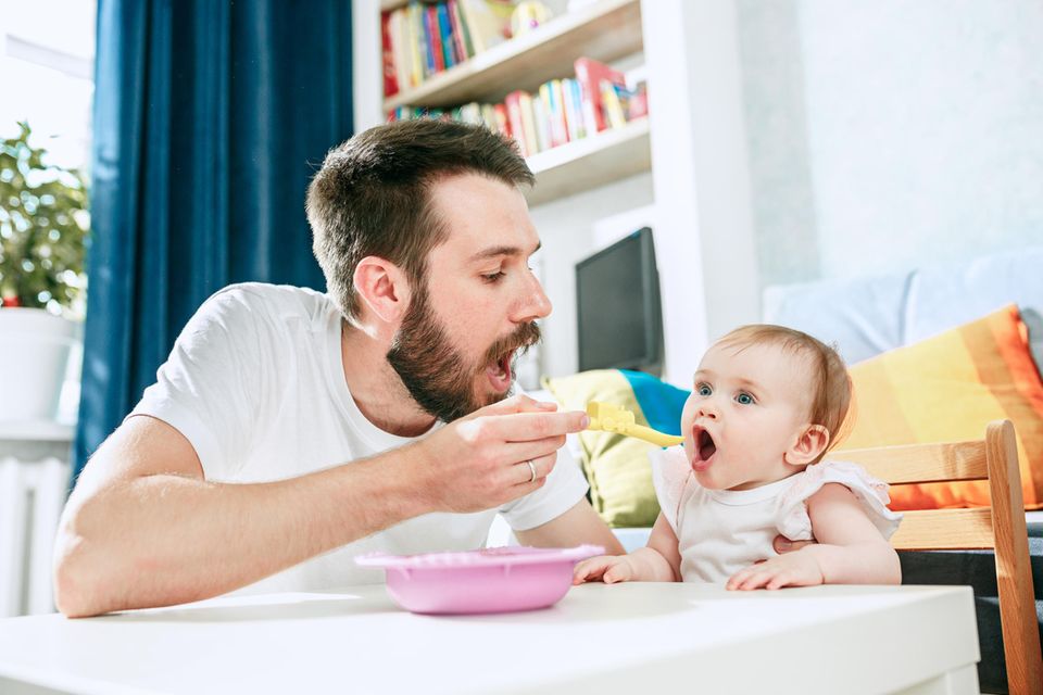 Beikostreifezeichen: Vater füttert Baby